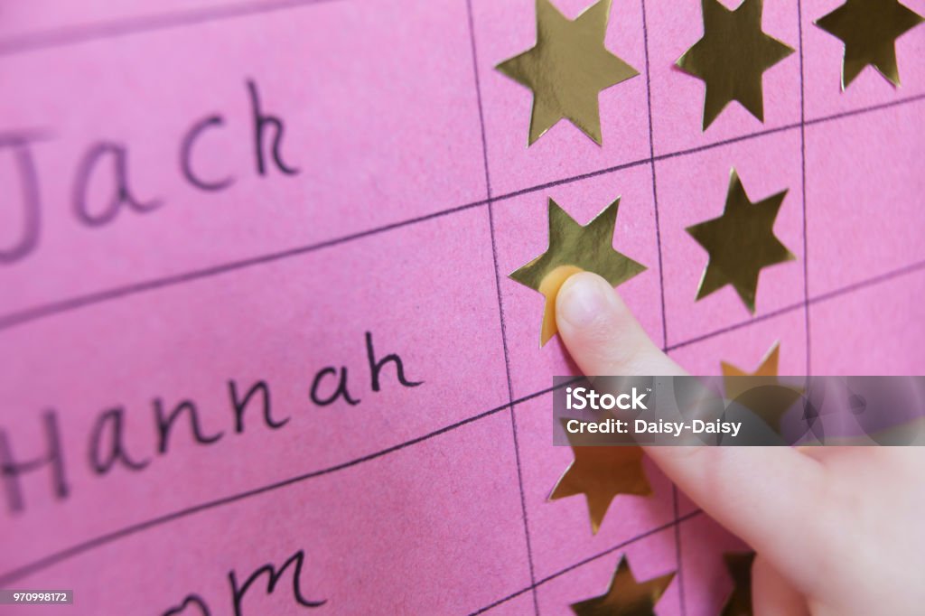 Close Up Of Child With Reward Chart Incentive Stock Photo