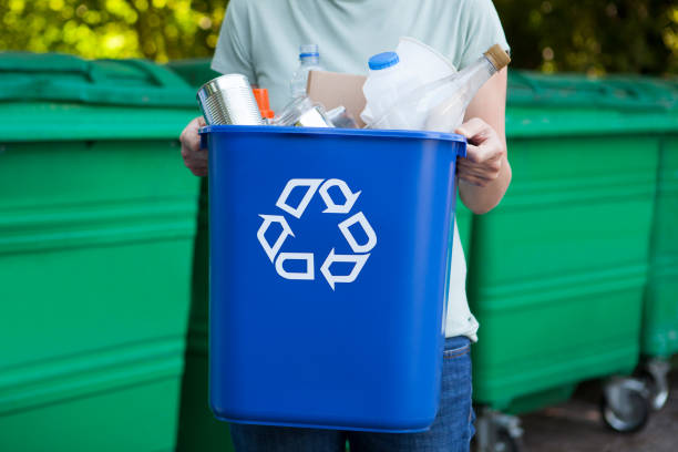 Close Up Of Woman Carrying Recycling Bin Close Up Of Woman Carrying Recycling Bin recycling bin photos stock pictures, royalty-free photos & images