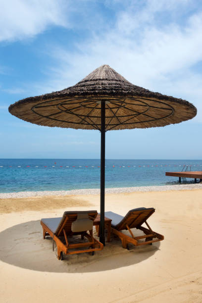 istock Beach chairs with umbrella and beautiful sand beach 971001278