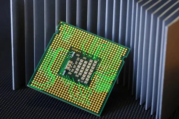 detail of cpu chip processor on aluminum heat sink cooler and electronic circuit effects