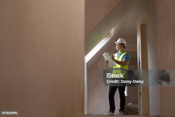 Inspector On Building Site With Clipboard Stock Photo - Download Image Now - Construction Industry, Quality Control, Examining