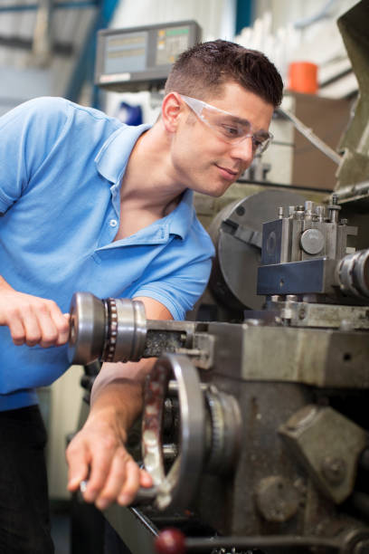 istock Male Engineer Operating Lathe In Factory 971002190