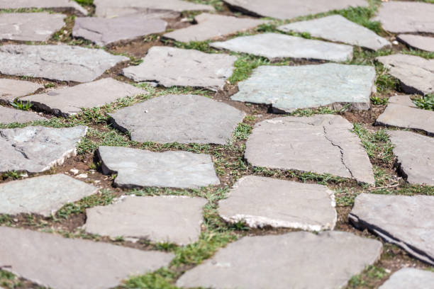 istock Stone pavement texture. Abstract background of old cobblestone pavement 971002300