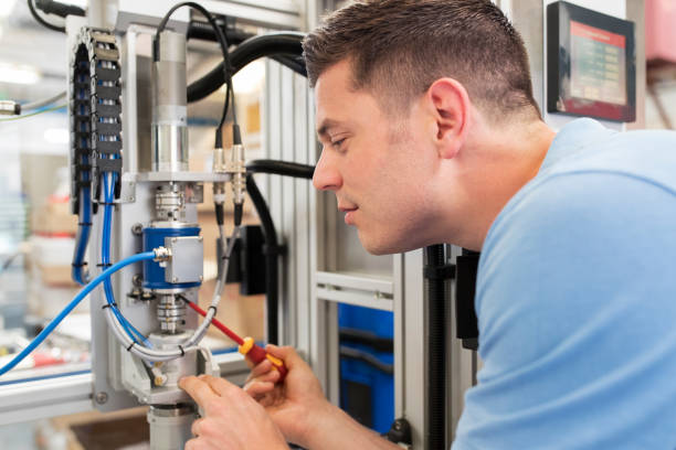 istock Male Engineer Working On Machine In Factory 971004492