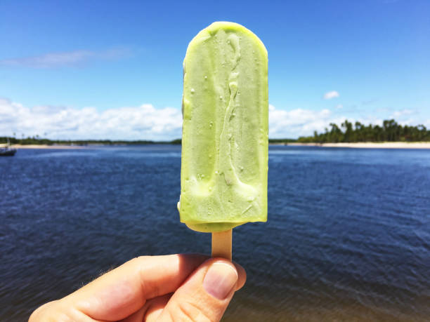 istock Hand Holding Green Avocado Ice Cream Popsicle 971005000