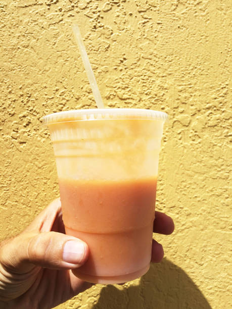 istock Hand Holding Colorful Juice Smoothie 971005160