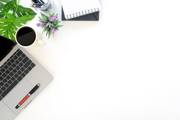istock Desk work with laptop, coffee, notebook paper, pen and plant decoration workspace top view. 971008502