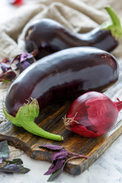 istock Aubergines and purple basil on a cutting board. 971012332