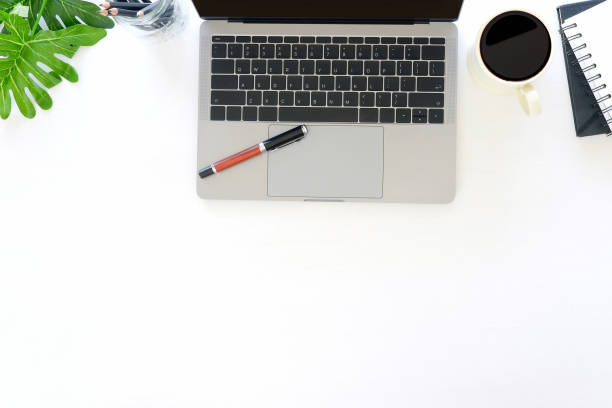 istock Office desk with workspace laptop computer, pen, coffee, notebook paper with copy space. 971012442