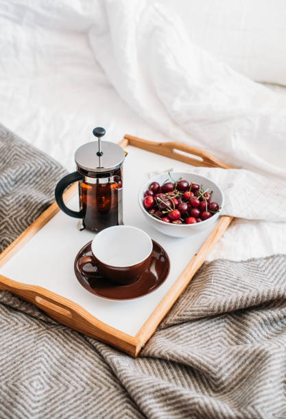istock Fresh healthy vegan breakfast in bed, green tea and cherry in mo 971015484