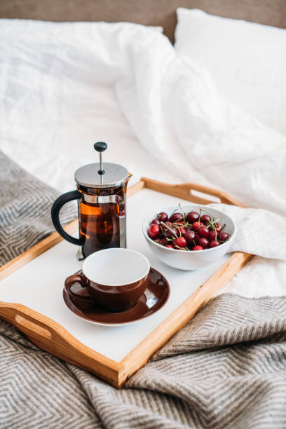 istock Fresh healthy vegan breakfast in bed, green tea and cherry in mo 971015600