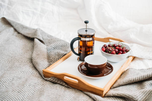 istock Fresh healthy vegan breakfast in bed, green tea and cherry in mo 971018012