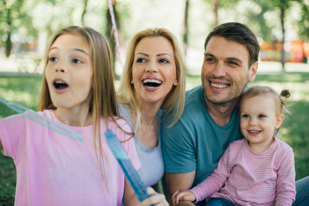 istock Young family with two daughters smiling 971021594