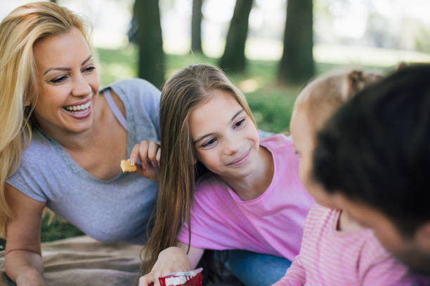 istock Woman eating snacks with her daughter 971021988