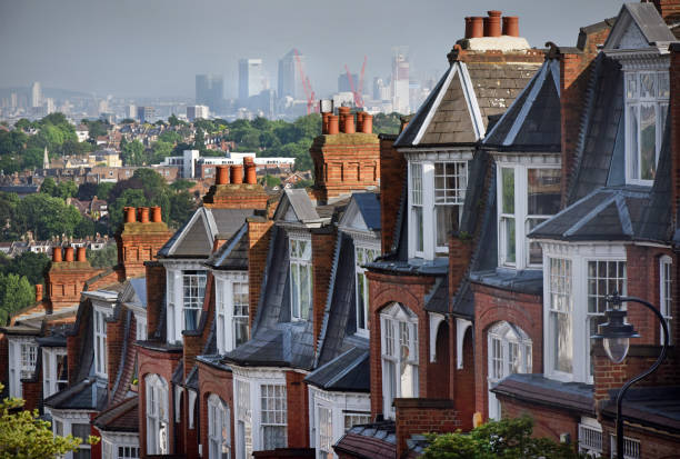 London Houses The view over Victorian terraced house at Muswell Hill in North London looking towards the East and skyscrapers of Canary Wharf financial district window chimney london england residential district stock pictures, royalty-free photos & images