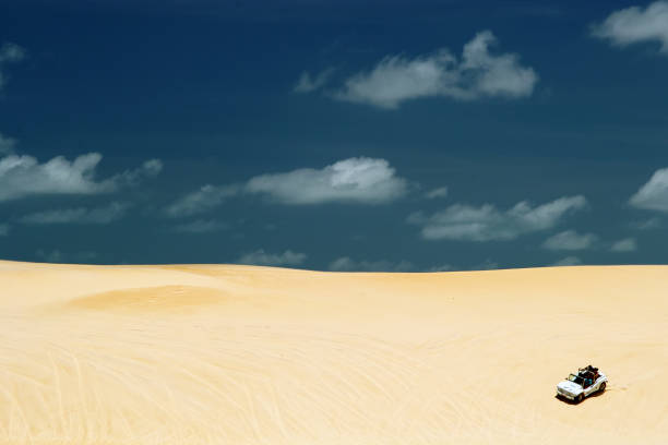 Beach-buggy with its tourist passengers races along the dunes at Genipabu near Natal, northeast Brazil