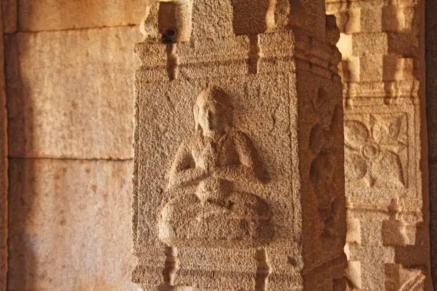 Stone bas-reliefs on the column in Hazara Rama Temples Hampi. Carving stone ancient background. Carved figures made of stone. Unesco World Heritage Site. Karnataka, India. Buddha, Krishna.