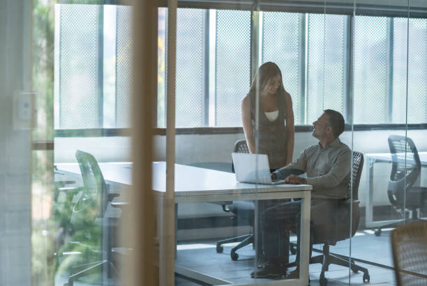 istock Two business people working together at the office 971043434