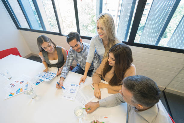 istock Business people looking at documents in a meeting 971043530