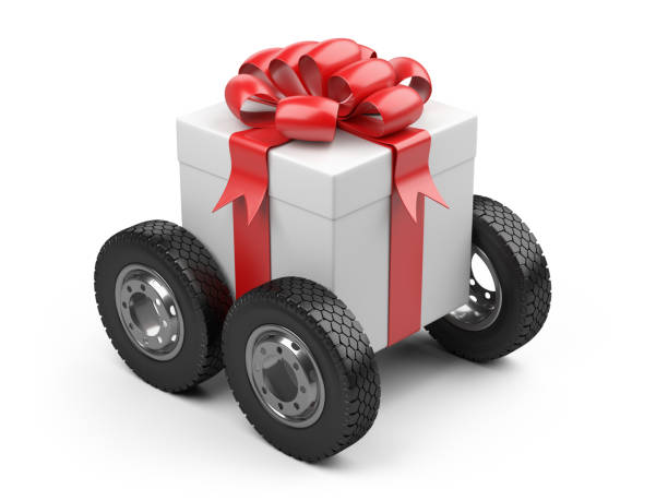 istock Gift box on a big tires wheels. 971043936