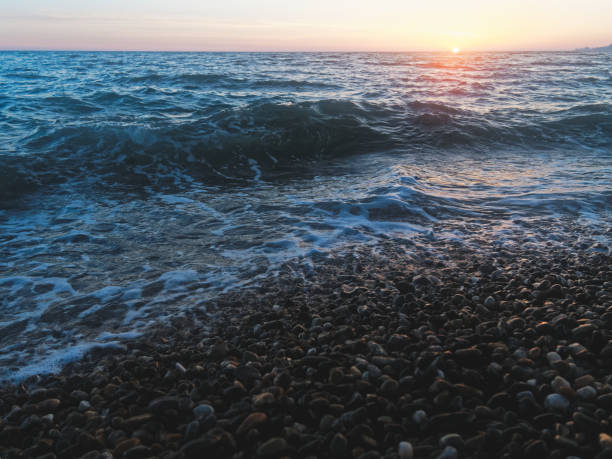 istock Sea surf at sunset 971044280
