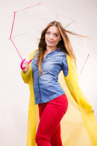 istock Woman wearing waterproof coat under umbrella 971047016