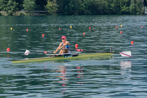 Front view of young female rowing women in the action