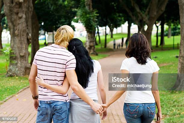 Man Holding Hands With A Woman While Another Woman Holds Him Stock Photo - Download Image Now