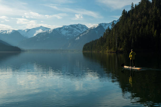 istock Woman stand up paddle boarding on a pristine mountain lake 971053042