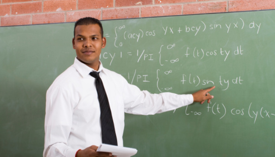 math teacher pointing at blackboard