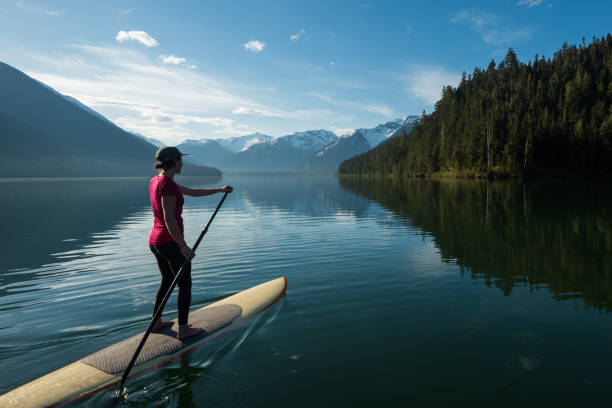 istock Woman stand up paddle boarding on a pristine mountain lake 971053432