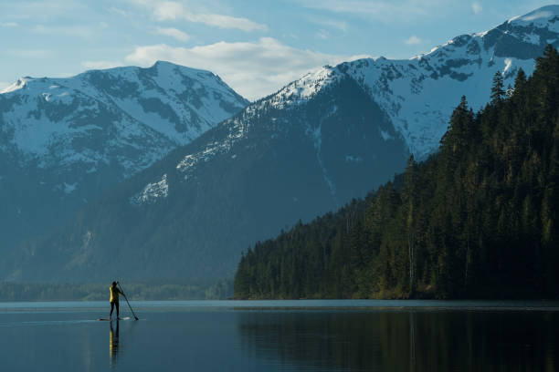 istock Woman stand up paddle boarding on a pristine mountain lake 971053562