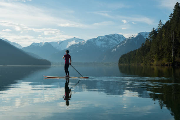istock Woman stand up paddle boarding on a pristine mountain lake 971053574