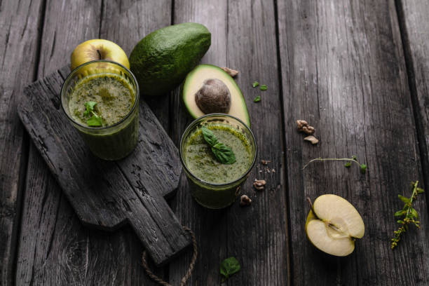 istock Organic fruit smoothie with avocado on wooden background 971057246
