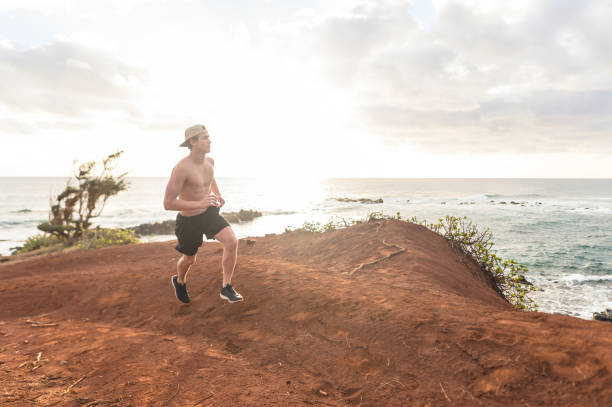 istock Solo shirtless jogger on Hawaii coastline 971057528