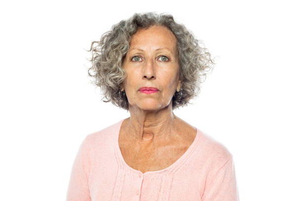 Senior woman in casuals looking serious Portrait of senior woman in casuals looking serious against white background. Caucasian woman with short grey hair. green eyes photos stock pictures, royalty-free photos & images