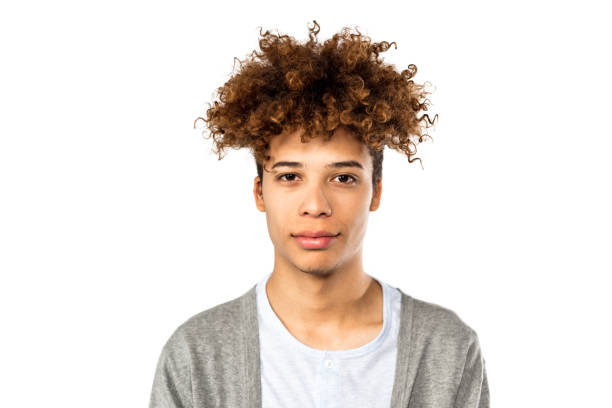 Portrait of handsome young afro american man Close up portrait of serious young afro american man. Male model with curly hair against white background. blank expression photos stock pictures, royalty-free photos & images