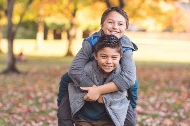 istock Two elementary-age boys walk to school through the park 971068158