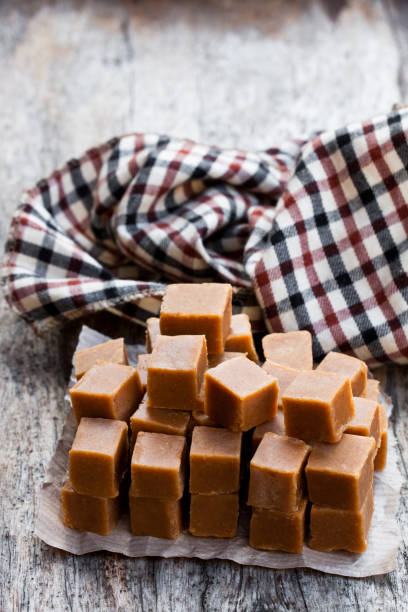 istock Toffee  cubes on wooden table 971070312