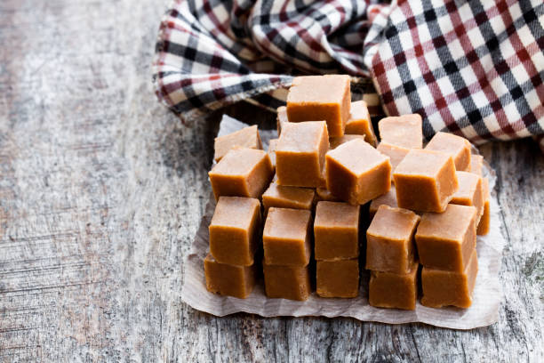 istock Toffee  cubes on wooden table 971070434