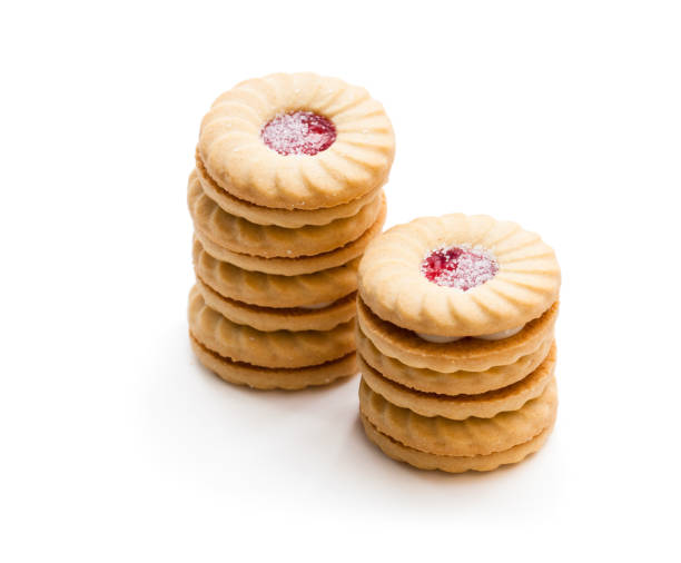 istock Stacked  shortcake biscuits sandwiched with cream and jam isolated on white 971070546