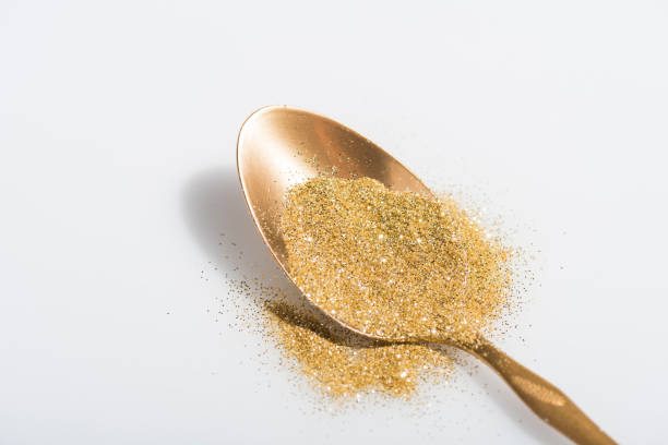 istock golden spoon and bright glitter on white 971070656