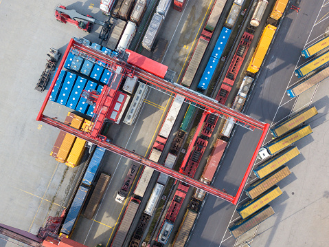 Cargo trains, trucks and a huge crane at freight terminal, Wels, Austria