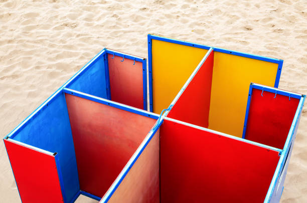 istock Multicolored beach changing rooms at the sandy beach 971075496