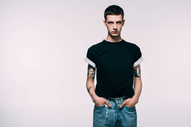 istock Handsome young man with tattoos on arms isolated on white 971075862