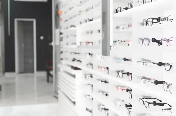 exhibitor of glasses consisting of shelves of fashionable glasses shown on a wall at the optical shop