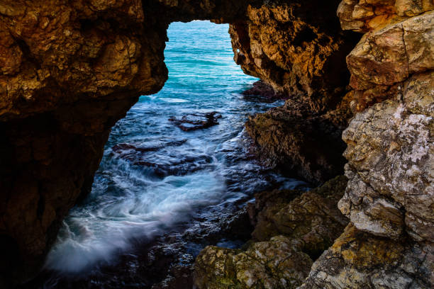 istock Cave that goes right trough mountain 971087102
