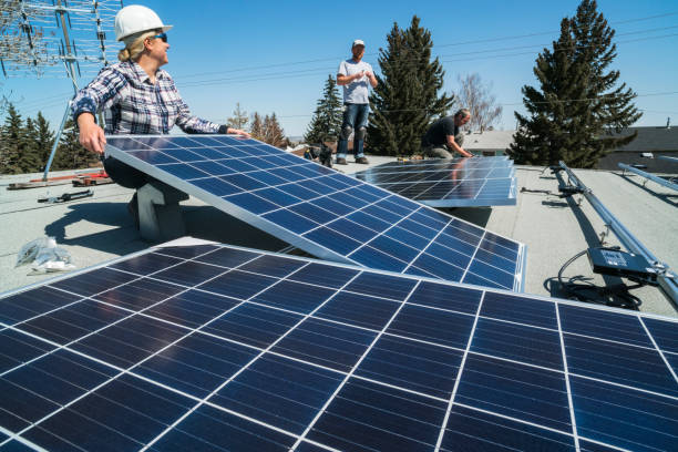 Solar Panel Installation Workers installing solar panels on a residential homes roof. rooftop solar stock pictures, royalty-free photos & images