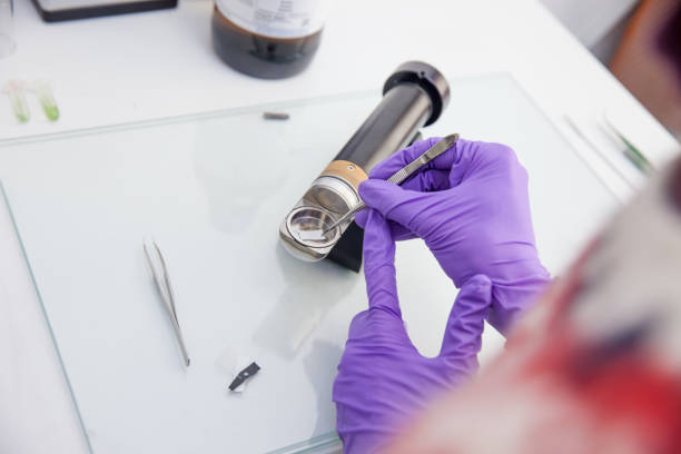 istock Woman Researcher Preparing Sample for Planar Surface Preparation Machine 971089946