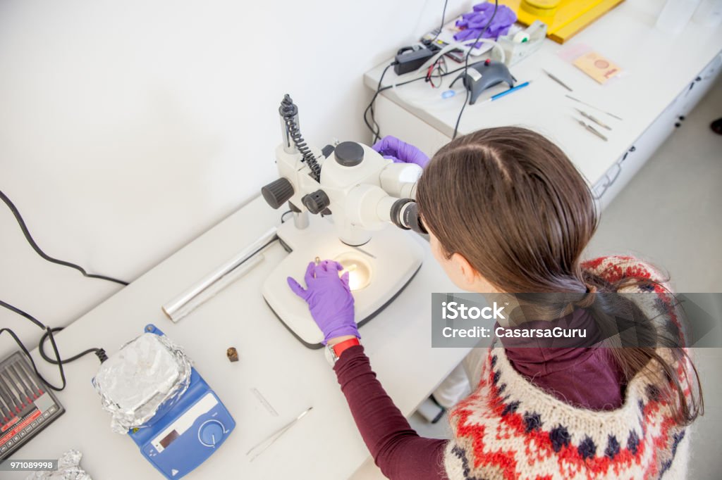Woman Scientist Researching Material Sample With Microscope Woman Scientist Researching Material Sample With Microscope. Accuracy Stock Photo